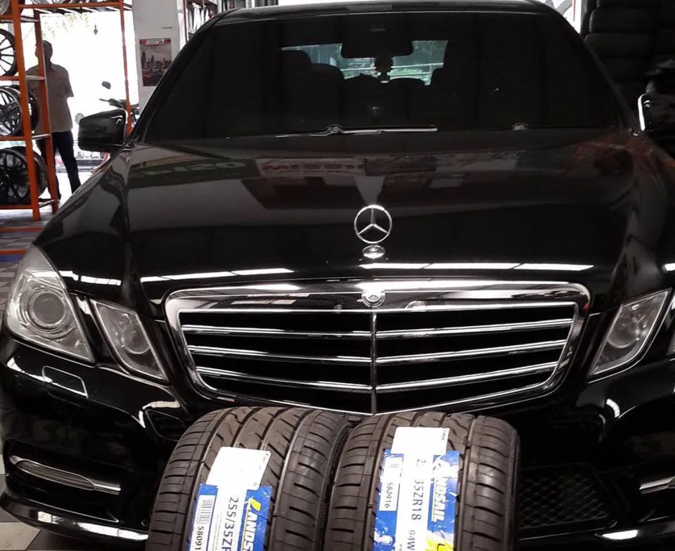 A car and new tyres inside the Carr Tyres workshop