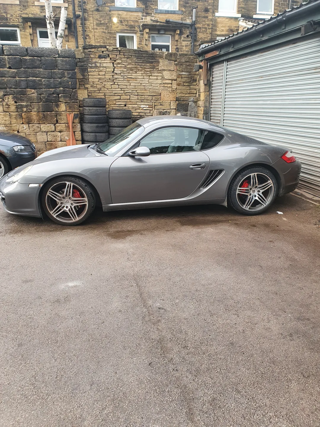 Silver sports car in the yard outside the Carr Tyres workshop